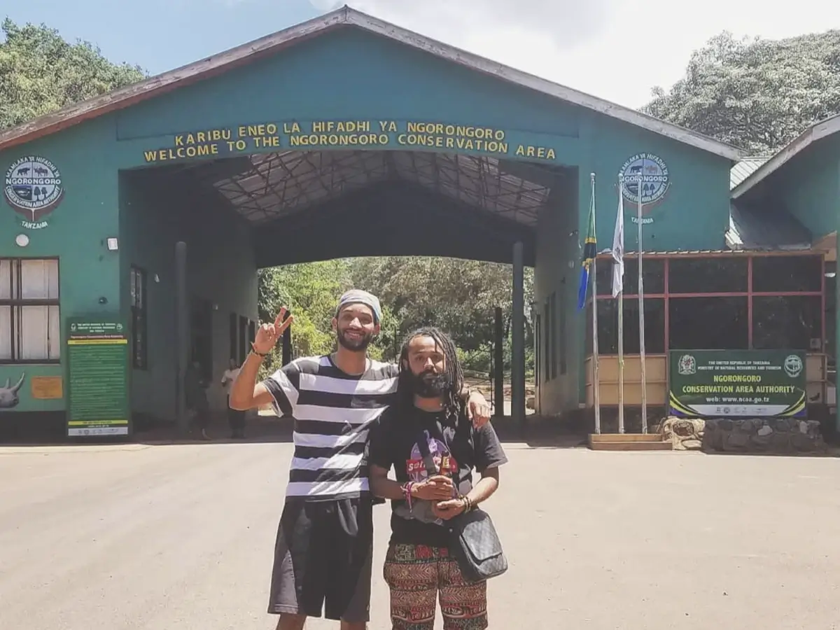 Crvne and his brother standing in front of the entrance to Ngorongoro Conservation Area, located in Serengeti National Park in Tanzania, East Africa.