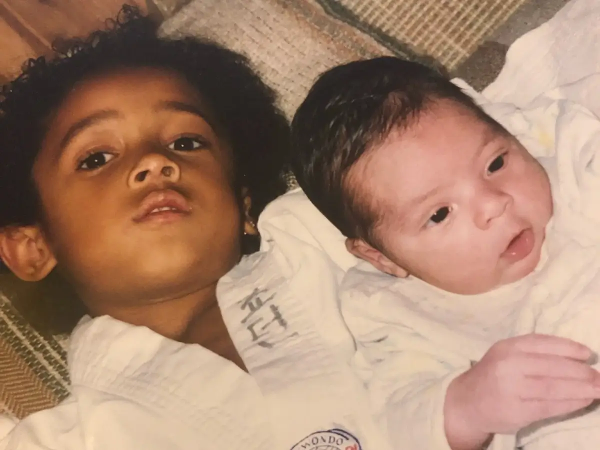 Crvne as a child holding his younger brother.